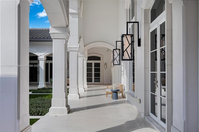 property entrance with a porch and french doors