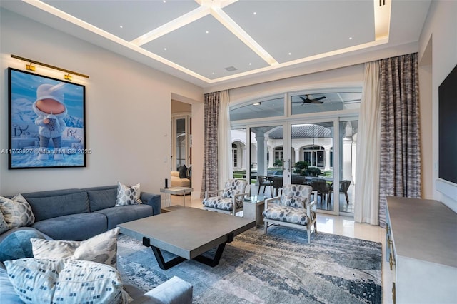 living area featuring a towering ceiling and coffered ceiling