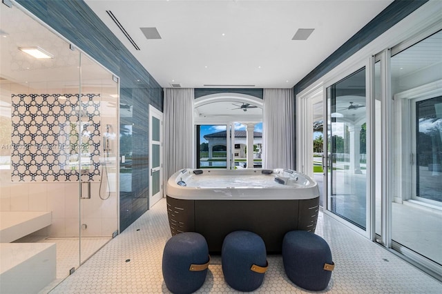 bathroom with ceiling fan and tile patterned flooring