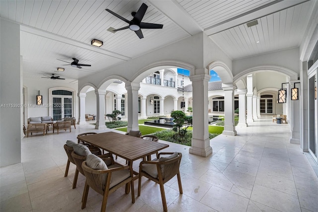 view of patio with outdoor dining space, french doors, an outdoor hangout area, and a ceiling fan