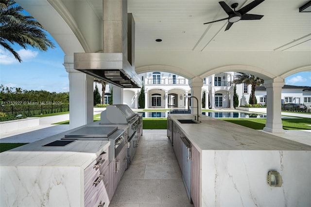 view of patio / terrace with area for grilling, a grill, a ceiling fan, and a sink