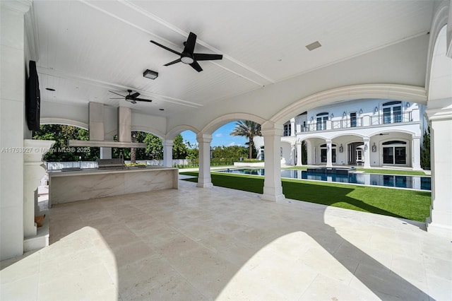 view of patio with an outdoor pool and ceiling fan