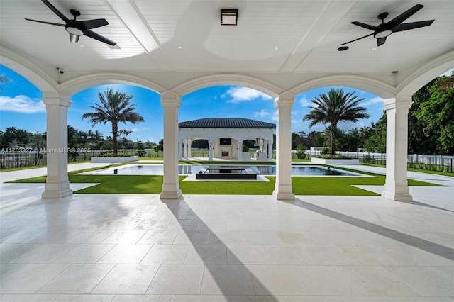 view of patio featuring a fenced in pool, ceiling fan, and fence