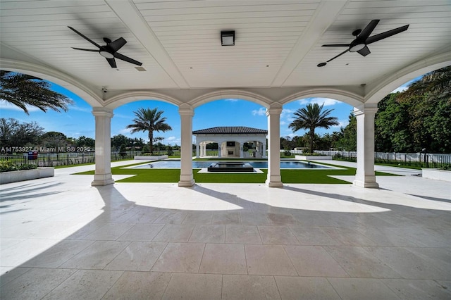 view of patio with a fenced in pool, ceiling fan, and fence