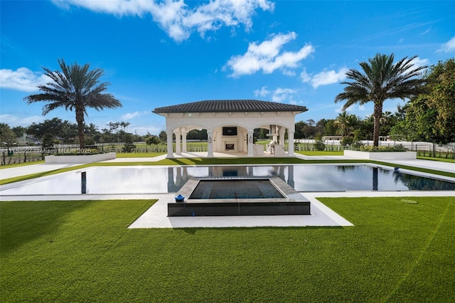 view of swimming pool featuring a gazebo, a yard, and fence