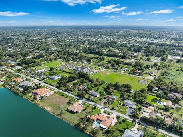 drone / aerial view with a water view and a residential view