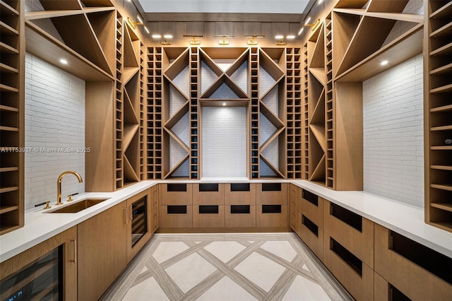 wine area with a sink and beverage cooler