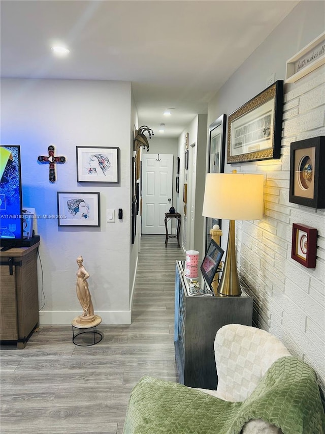 hall with wood finished floors and baseboards