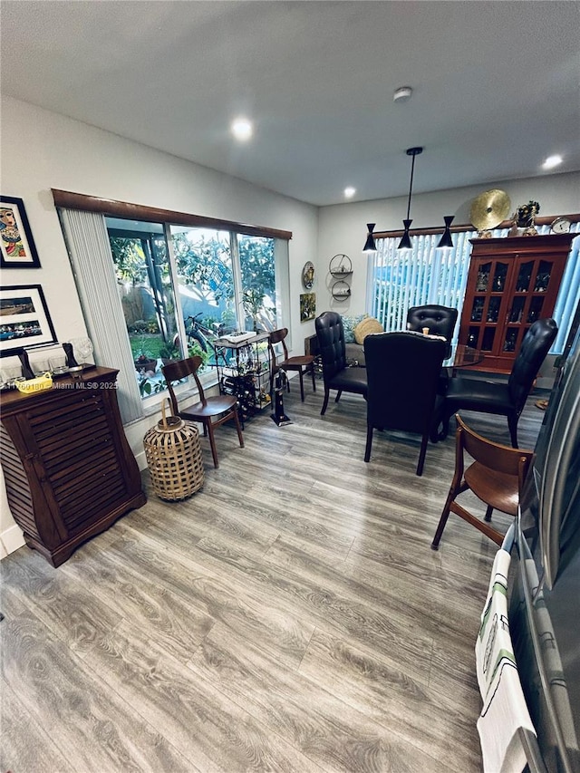 living area featuring recessed lighting, baseboards, and wood finished floors