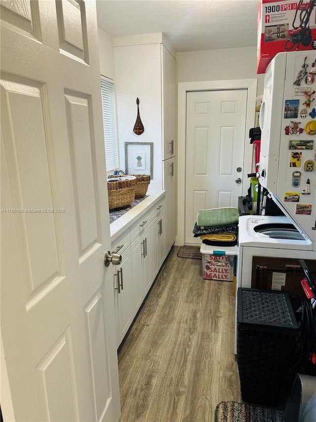 kitchen featuring white cabinetry, freestanding refrigerator, light countertops, and light wood finished floors