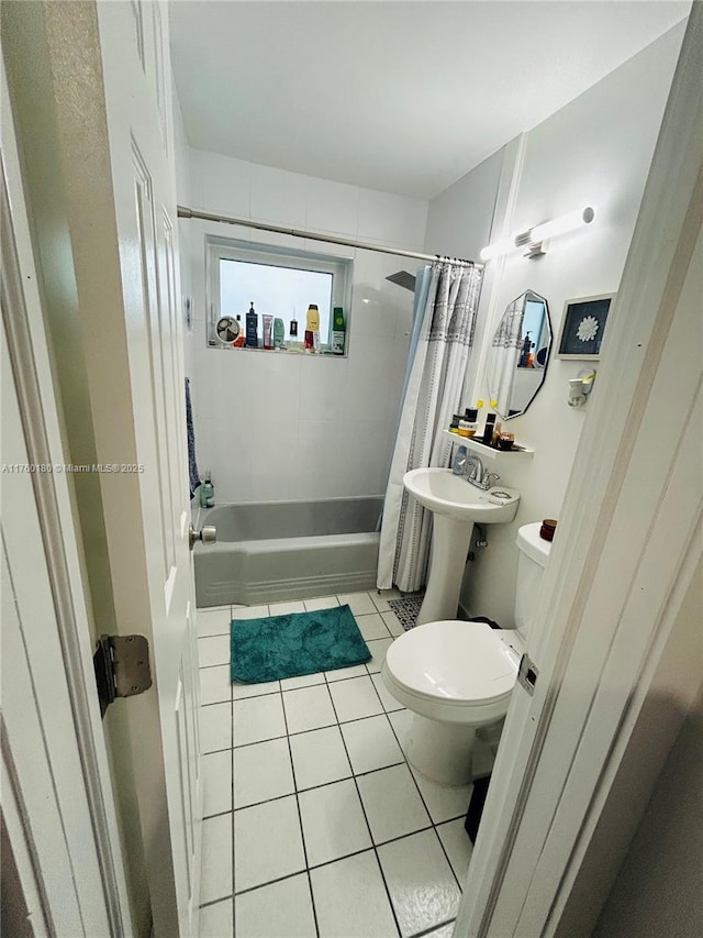 bathroom with tile patterned floors, toilet, and shower / tub combo with curtain