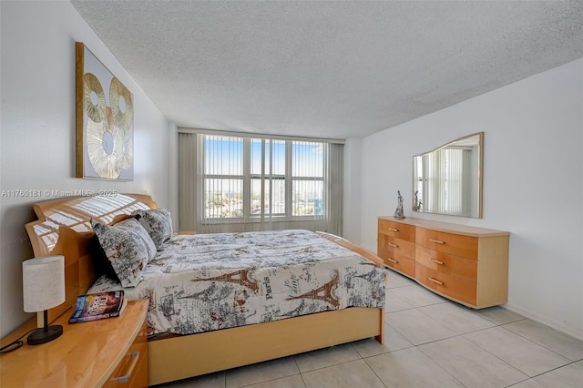 bedroom with light tile patterned floors and a textured ceiling