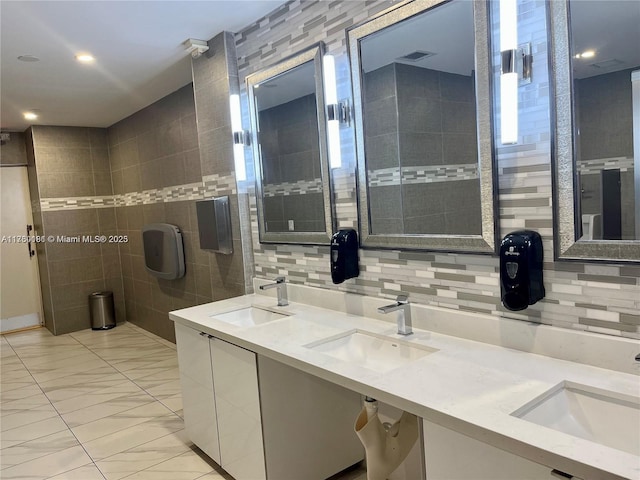 bathroom with a sink, tasteful backsplash, and double vanity