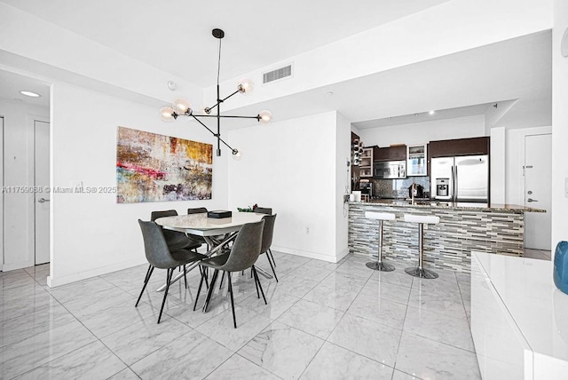 950 Brickell Bay Dr Unit 3605, Miami, FL 33131 - dining room with baseboards, visible vents, marble finish floor, and a chandelier
