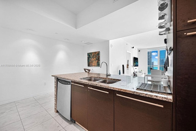 950 Brickell Bay Dr Unit 3605, Miami, FL 33131 - kitchen with a sink, stainless steel dishwasher, baseboards, dark brown cabinets, and light stone countertops