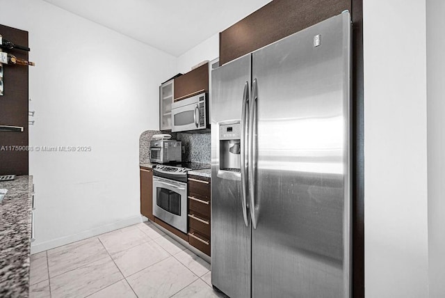 950 Brickell Bay Dr Unit 3605, Miami, FL 33131 - kitchen featuring dark brown cabinetry, decorative backsplash, appliances with stainless steel finishes, and light stone counters