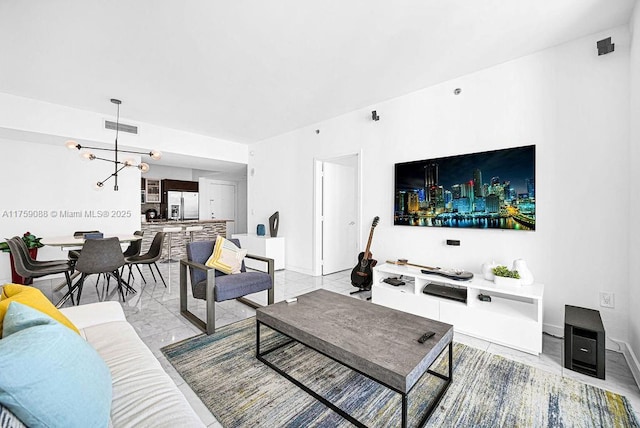 950 Brickell Bay Dr Unit 3605, Miami, FL 33131 - living room featuring a notable chandelier, visible vents, marble finish floor, and baseboards