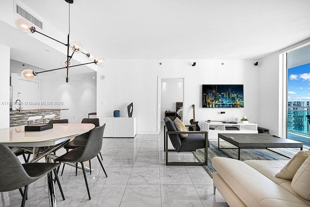 950 Brickell Bay Dr Unit 3605, Miami, FL 33131 - dining area featuring visible vents, marble finish floor, and an inviting chandelier