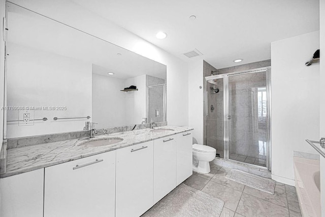 950 Brickell Bay Dr Unit 3605, Miami, FL 33131 - bathroom with a shower stall, double vanity, visible vents, and a sink