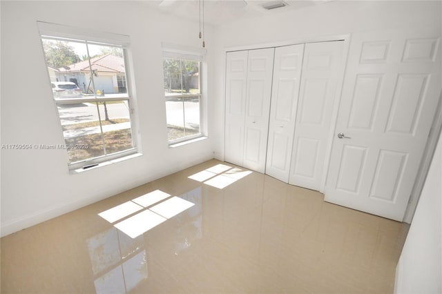 14065 S Cypress Cove Cir, Davie, FL 33325 - unfurnished bedroom with tile patterned floors, a closet, and visible vents