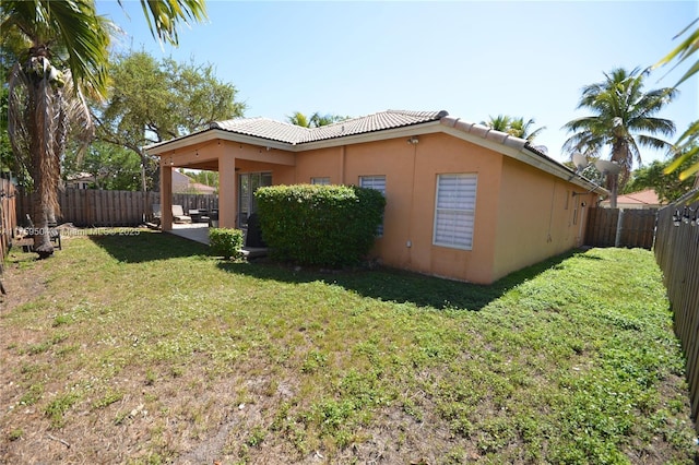 14065 S Cypress Cove Cir, Davie, FL 33325 - view of side of property with a lawn, stucco siding, a fenced backyard, and a tile roof