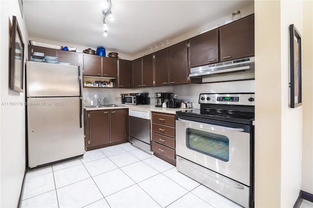 kitchen with light countertops, dark brown cabinetry, under cabinet range hood, and stainless steel appliances