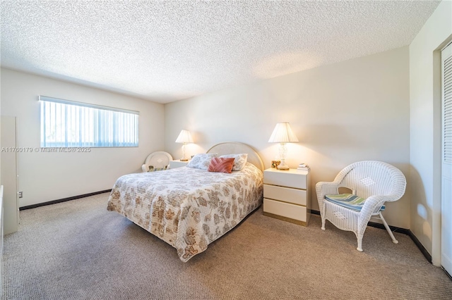 carpeted bedroom featuring baseboards and a textured ceiling