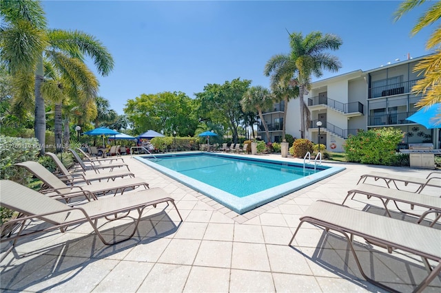 community pool with a patio area