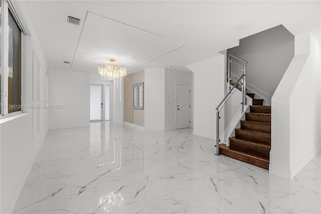 interior space with visible vents, marble finish floor, a chandelier, and stairs