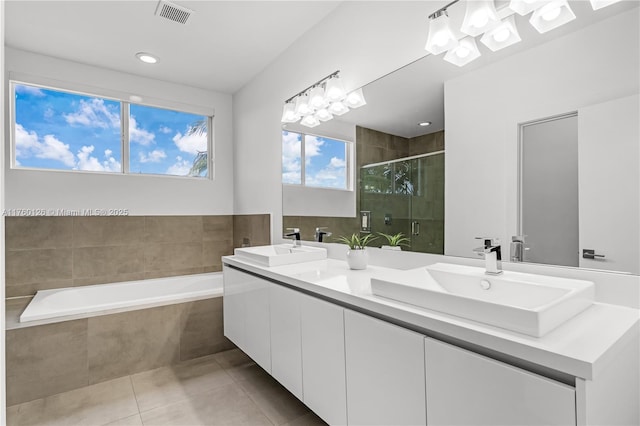 bathroom with a sink, visible vents, a shower stall, and tile patterned flooring