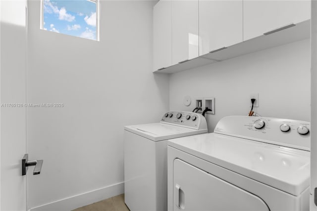 clothes washing area with light tile patterned floors, baseboards, cabinet space, and washing machine and dryer