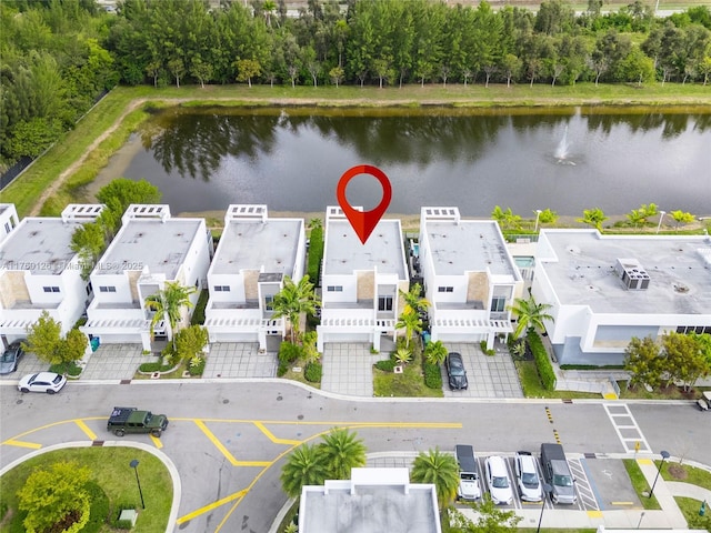 drone / aerial view featuring a residential view and a water view