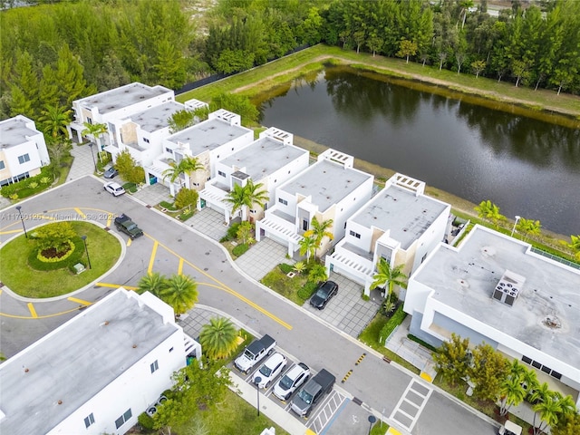 drone / aerial view featuring a residential view and a water view