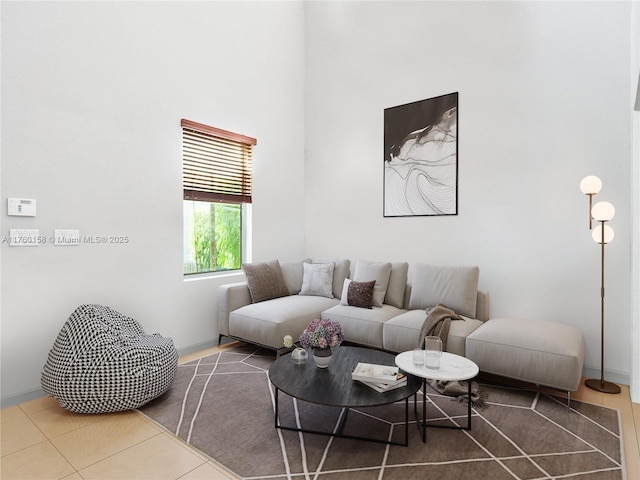 living area featuring a towering ceiling and tile patterned flooring