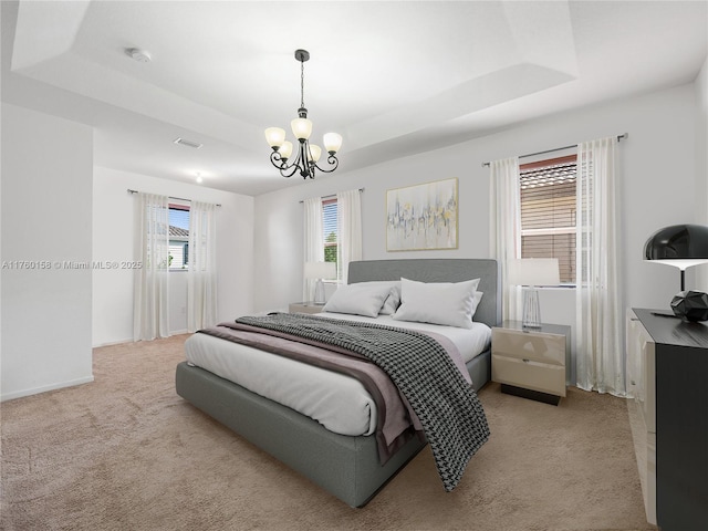 bedroom with visible vents, a raised ceiling, light carpet, and a chandelier