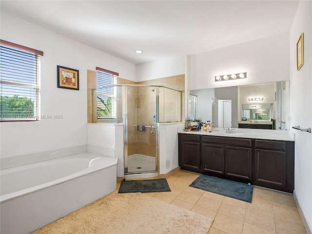 full bath featuring tile patterned flooring, a stall shower, vanity, and a bath