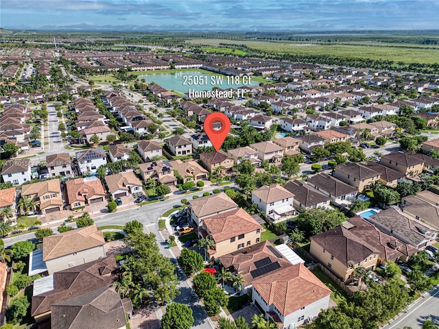 drone / aerial view featuring a residential view and a water view