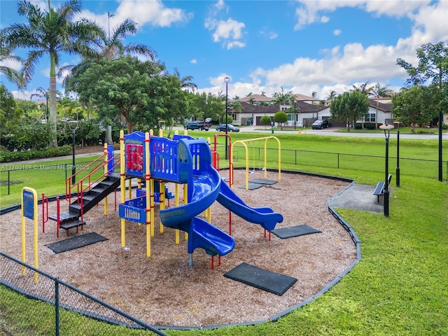 communal playground with a yard and fence