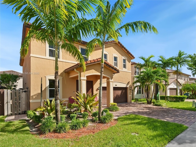 mediterranean / spanish-style home featuring a gate, driveway, stucco siding, a garage, and a tile roof