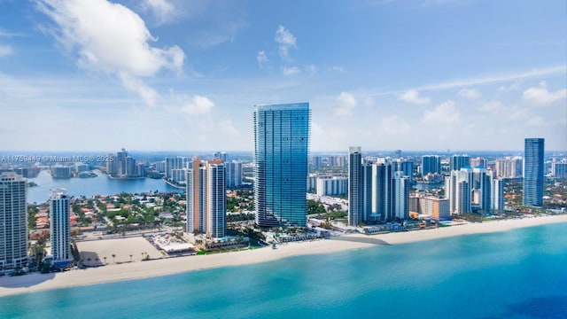 birds eye view of property featuring a city view, a view of the beach, and a water view