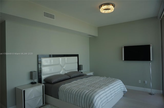 bedroom with visible vents and baseboards