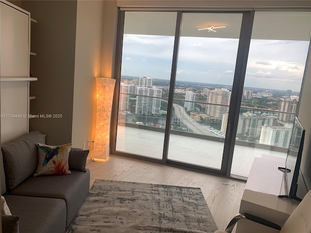 doorway to outside with a view of city and wood finished floors