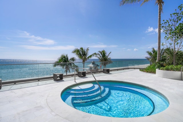 view of swimming pool with a patio, a swimming pool, and a water view