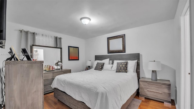 bedroom with wood finished floors