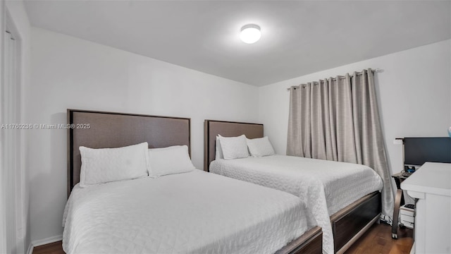 bedroom featuring dark wood-type flooring