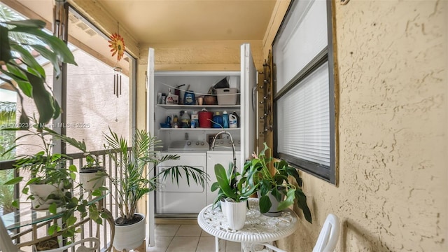 balcony with washing machine and clothes dryer