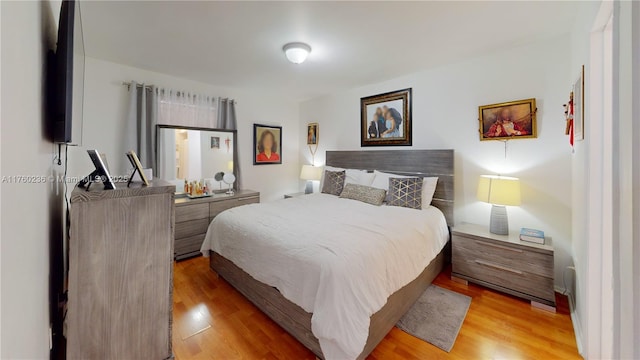 bedroom featuring light wood-style flooring
