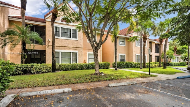 view of property with uncovered parking