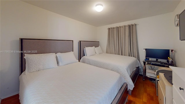 bedroom with dark wood-type flooring