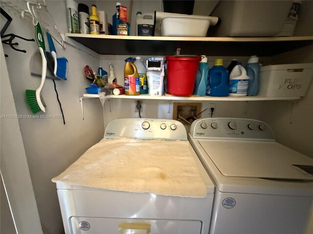 clothes washing area featuring washer and dryer and laundry area